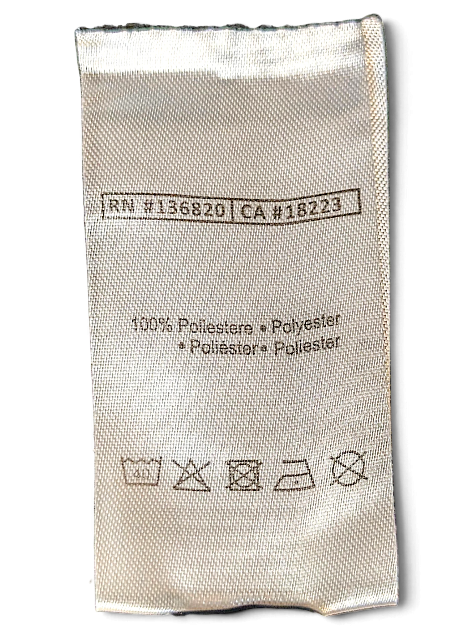 JAKE & IPI Kappa track pants care label showing 100 percent polyester composition and laundry instructions