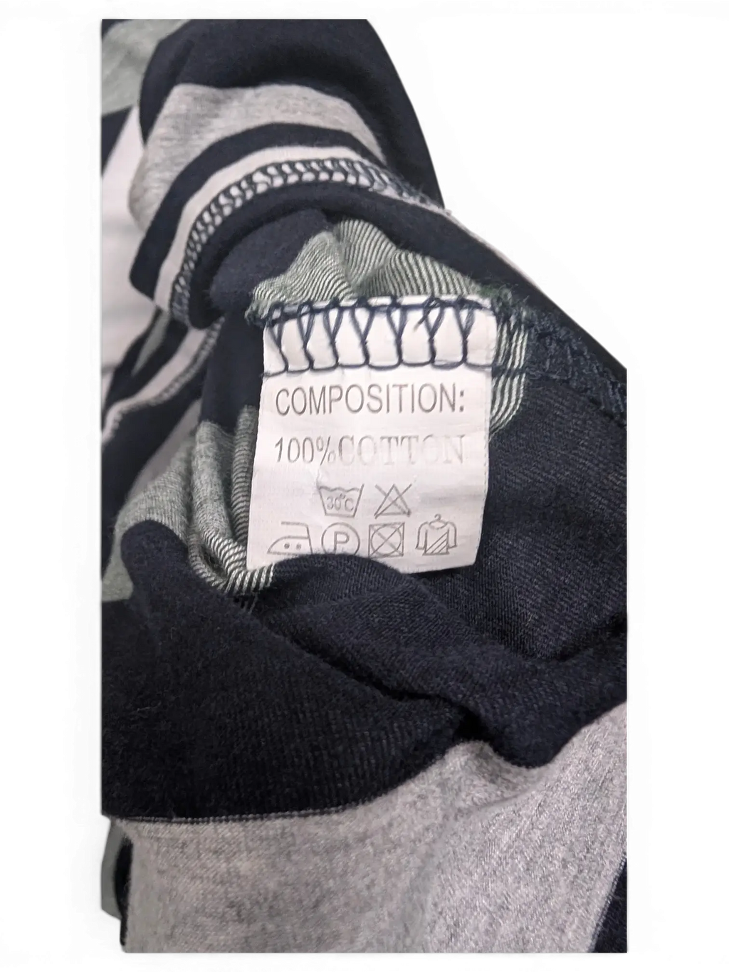 JAKE & IPI pre-owned Lacoste polo shirt care label showing 100 percent cotton composition on striped fabric