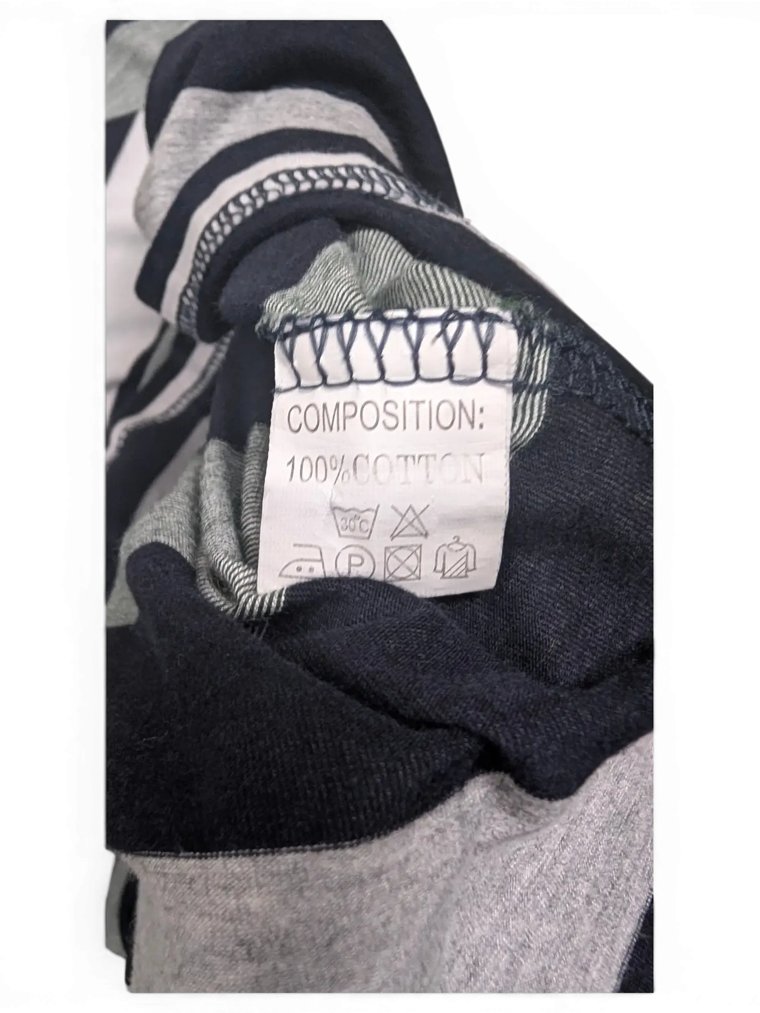 JAKE & IPI pre-owned Lacoste polo shirt care label showing 100 percent cotton composition on striped fabric