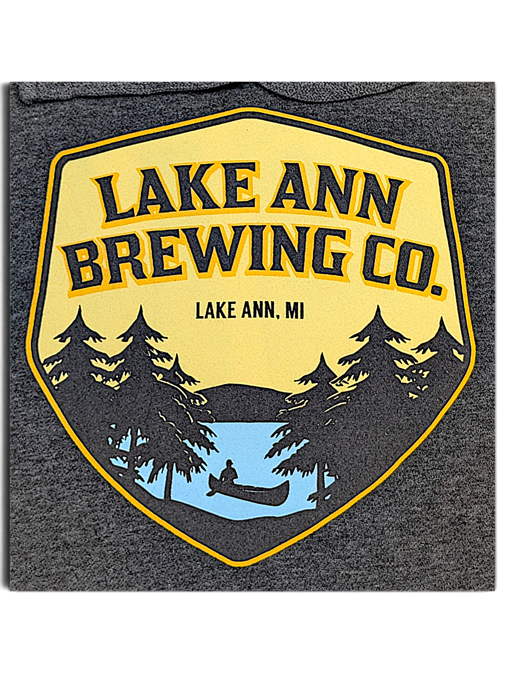JAKE & IPI charcoal grey hoodie featuring a Lake Ann Brewing CO logo with a canoe and pine tree graphic