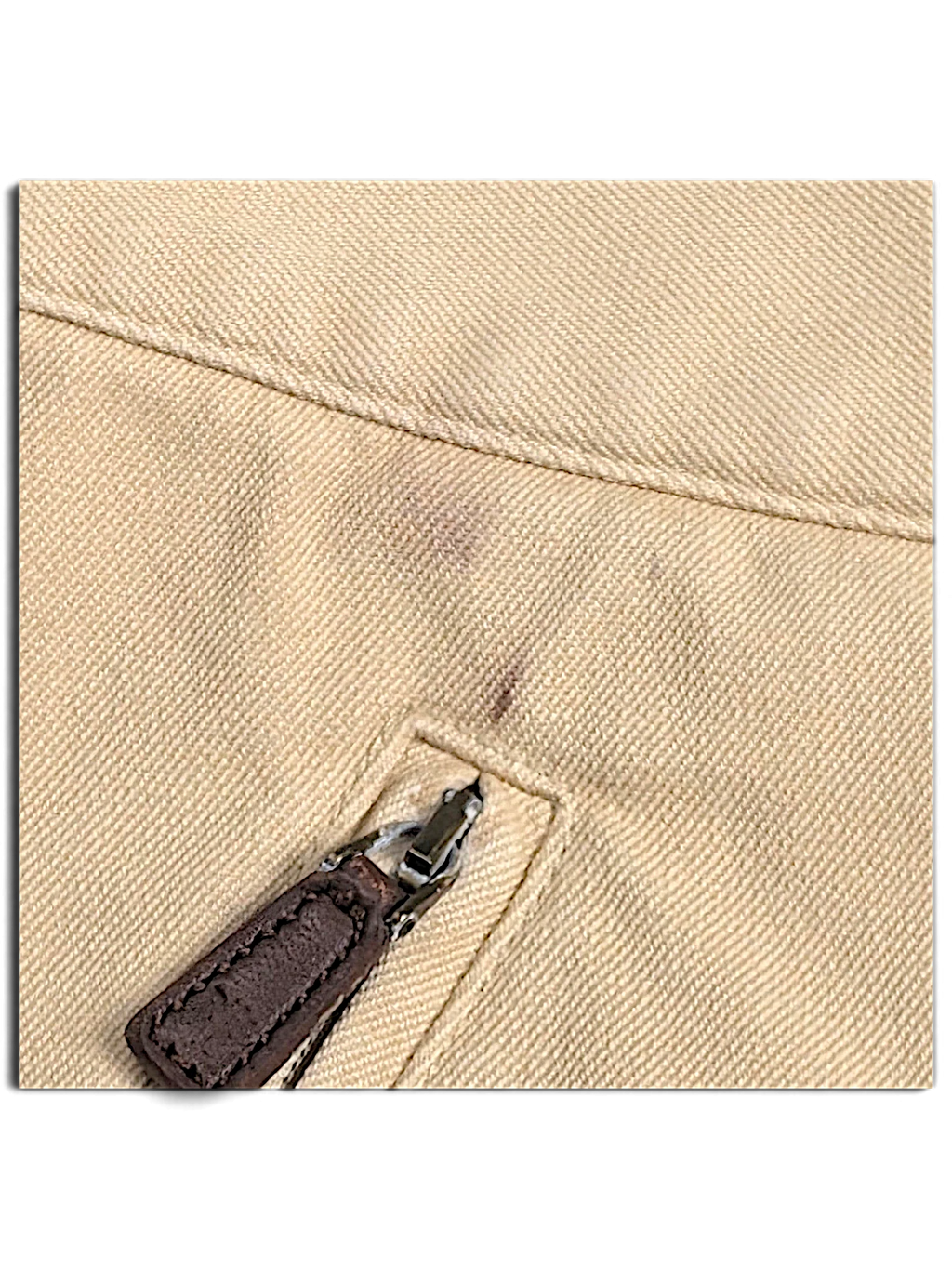 JAKE & IPI Lauren Ralph Lauren beige trousers showing a small mark near the zippered pocket and worn zipper pull