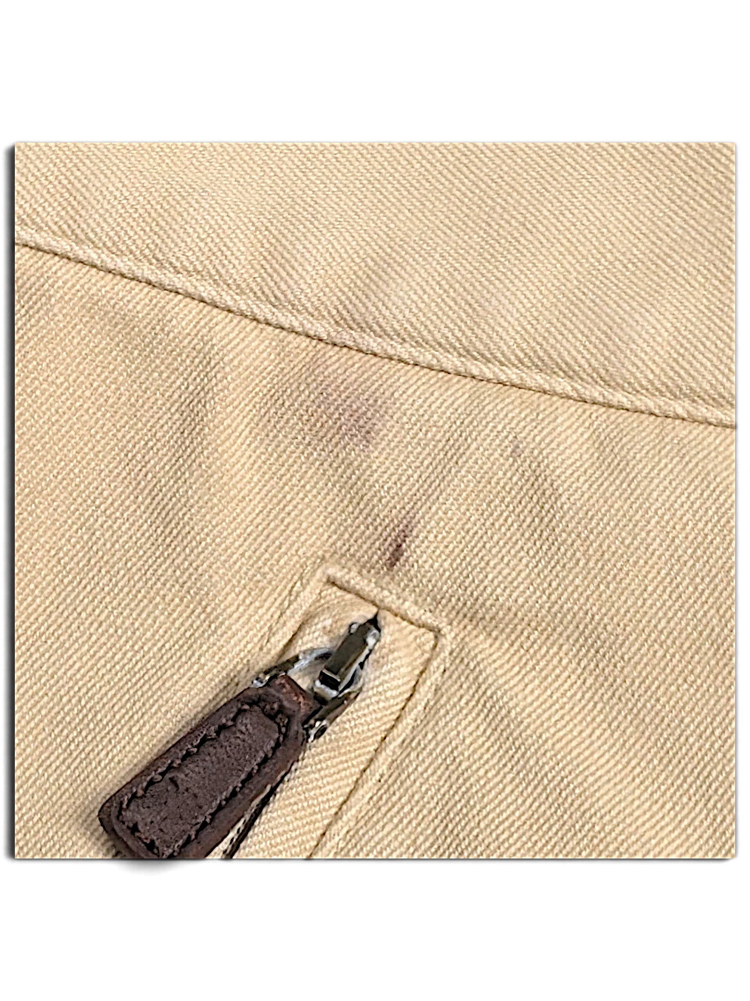 JAKE & IPI Lauren Ralph Lauren beige trousers showing a small mark near the zippered pocket and worn zipper pull