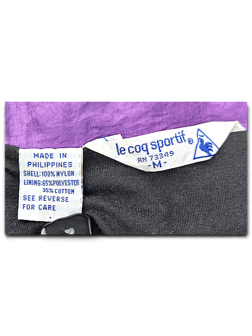 Le Coq Sportif Black and Purple Colourblock Windbreaker; Le Coq Sportif size M and fibre composition label.