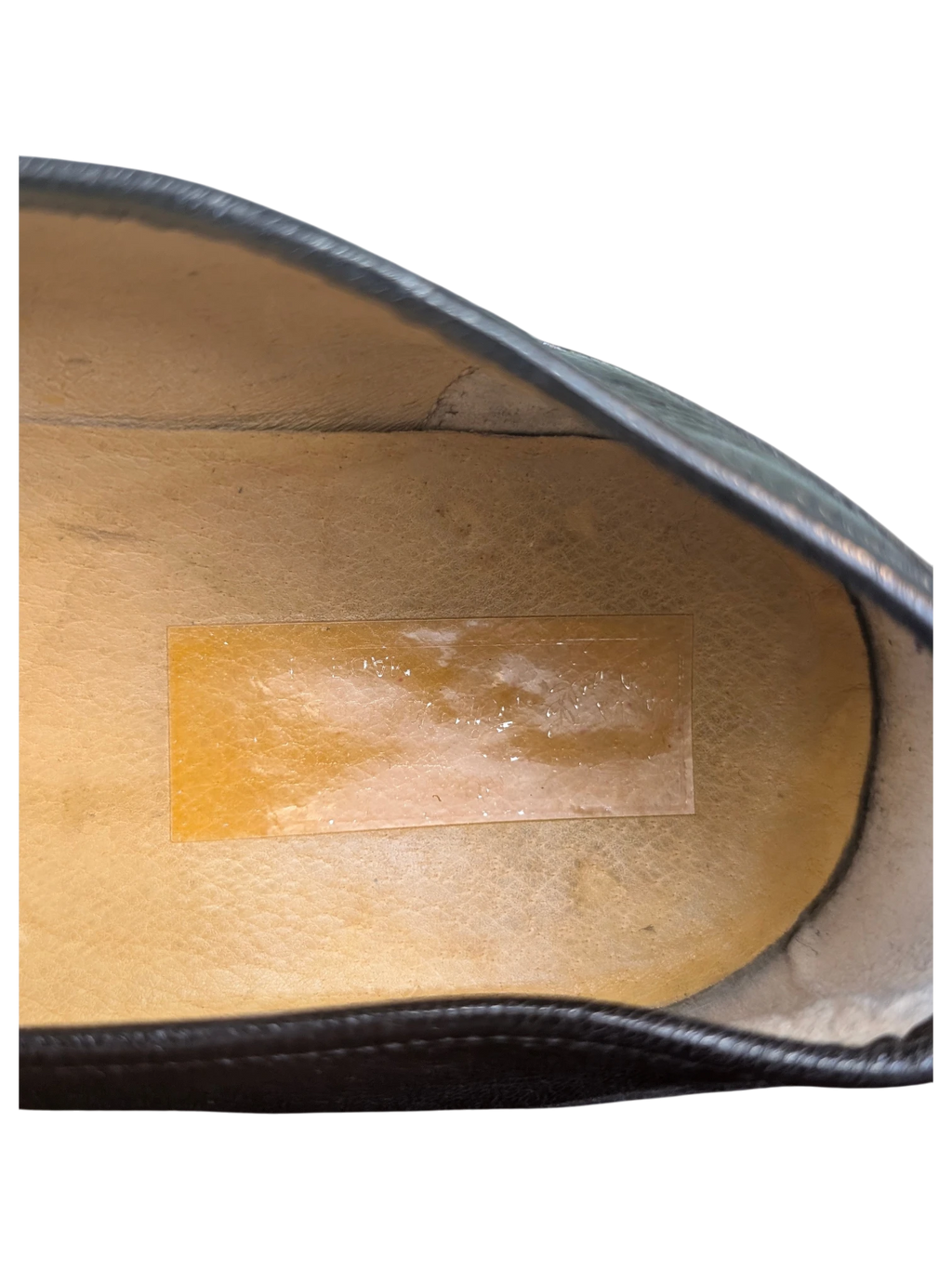 Interior view of a JAKE & IPI loafer showing the tan leather insole and dark leather lining