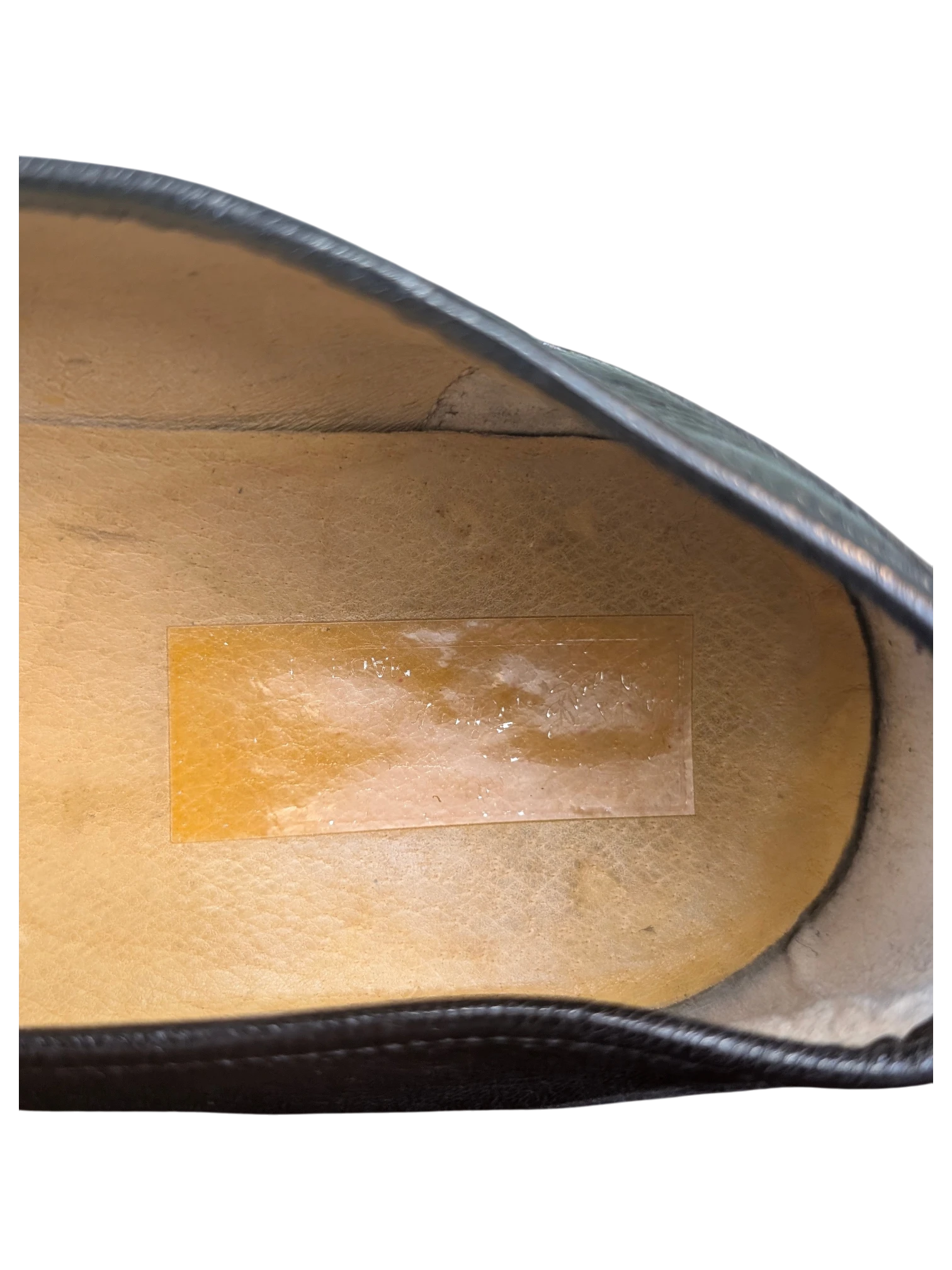 Interior view of a JAKE & IPI loafer showing the tan leather insole and dark leather lining
