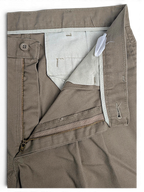 JAKE & IPI Lee Performance Khakis beige pleated trousers showing the zipper fly, button closure, and interior lining.