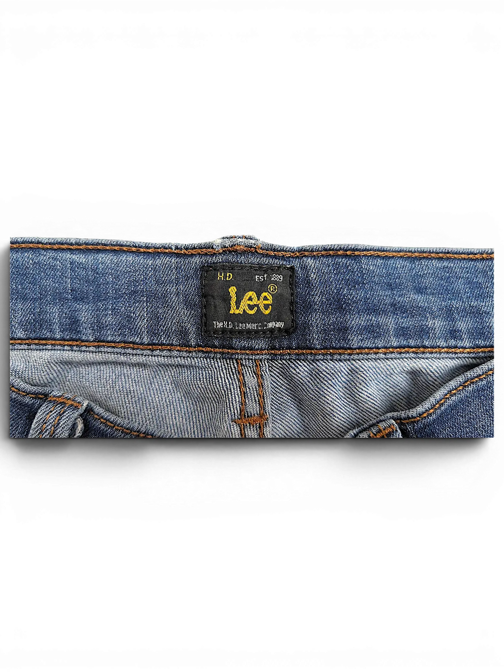 JAKE & IPI Lee Jade blue denim jeans featuring a black brand label on the inner waistband with gold embroidery