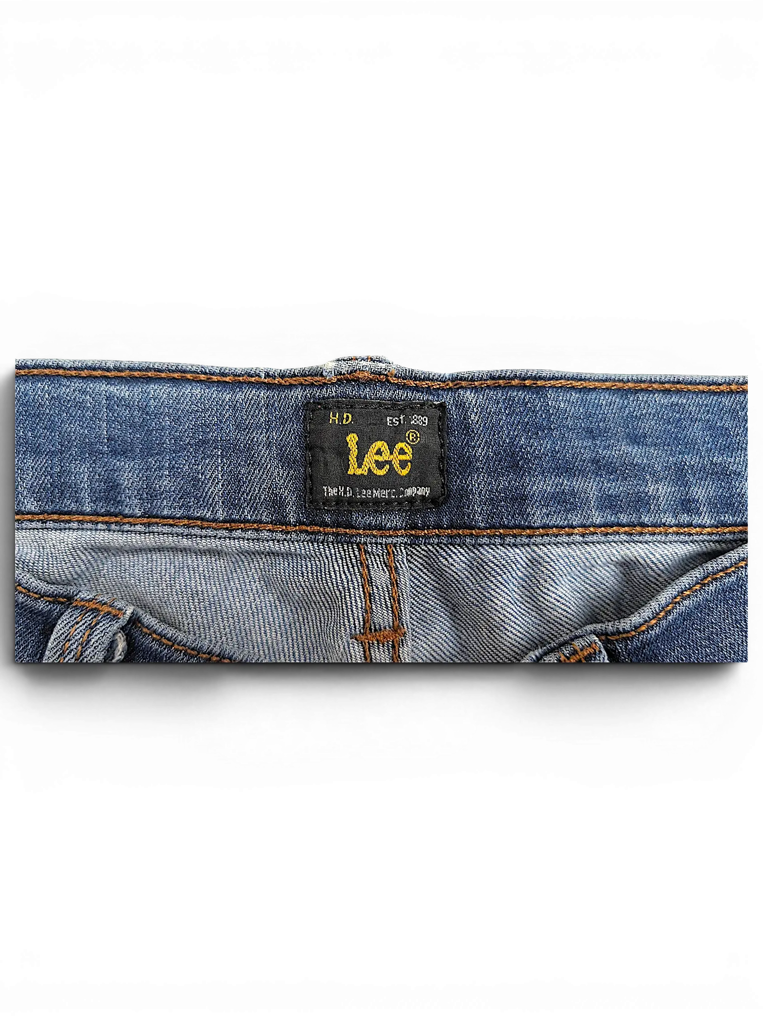 JAKE & IPI Lee Jade blue denim jeans featuring a black brand label on the inner waistband with gold embroidery