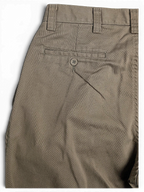 JAKE & IPI Lee Performance Khakis beige pleated trousers featuring a buttoned back pocket detail