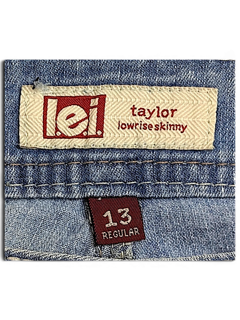 JAKE & IPI l.e.i. Taylor lowrise skinny jeans label with size 13 regular tag on blue denim fabric
