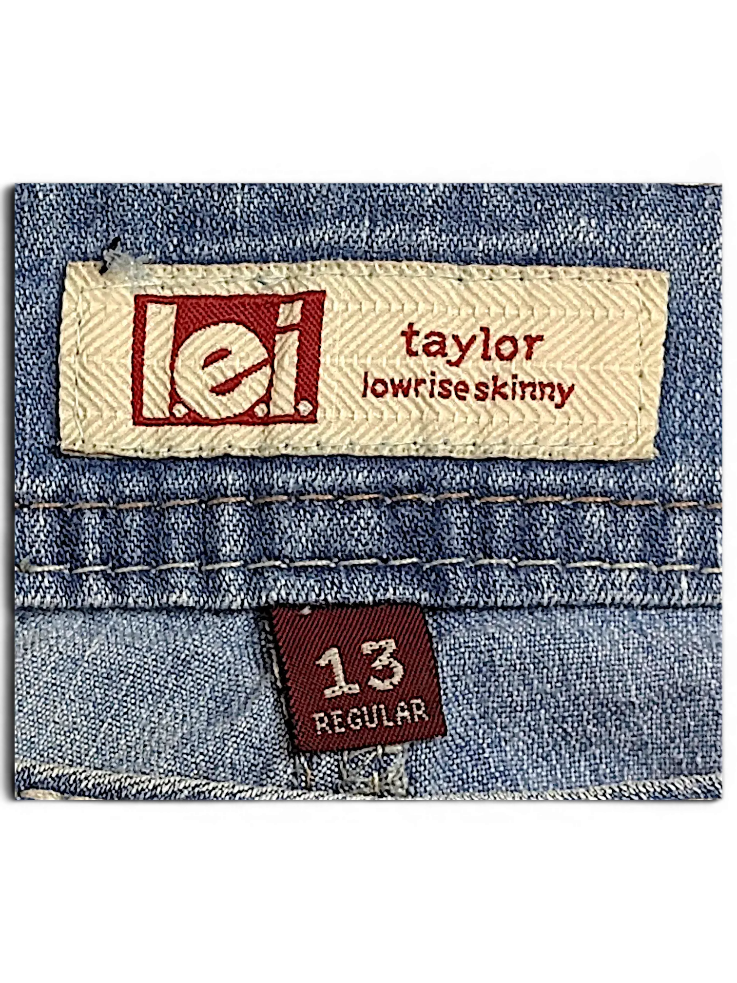 JAKE & IPI l.e.i. Taylor lowrise skinny jeans label with size 13 regular tag on blue denim fabric