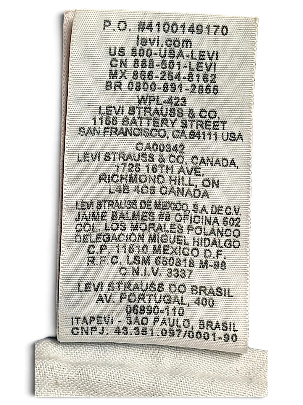 JAKE & IPI Levi's 514 jeans care label showing manufacturing and company information on light blue denim fabric