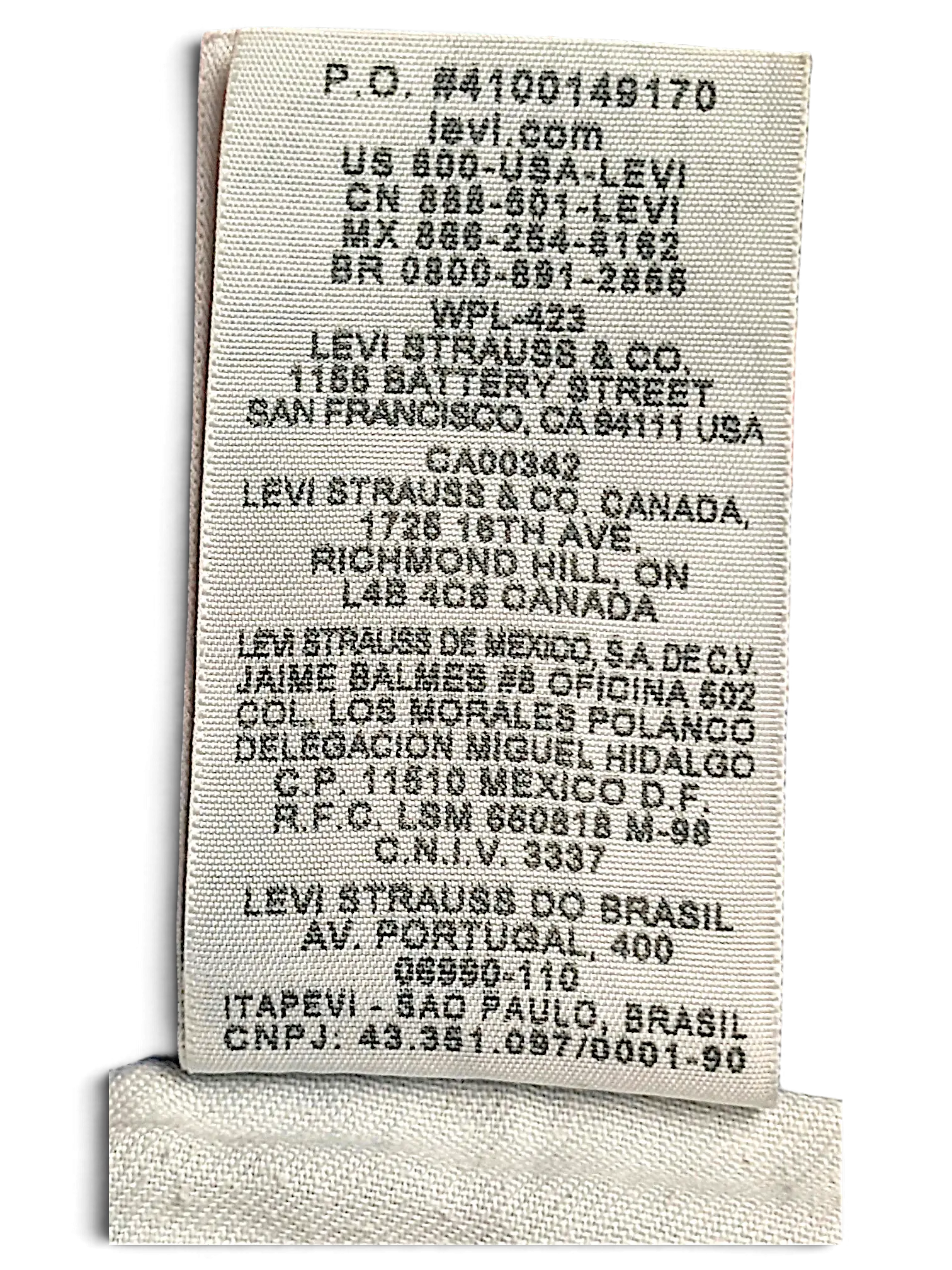 JAKE & IPI Levi's 514 jeans care label showing manufacturing and company information on light blue denim fabric