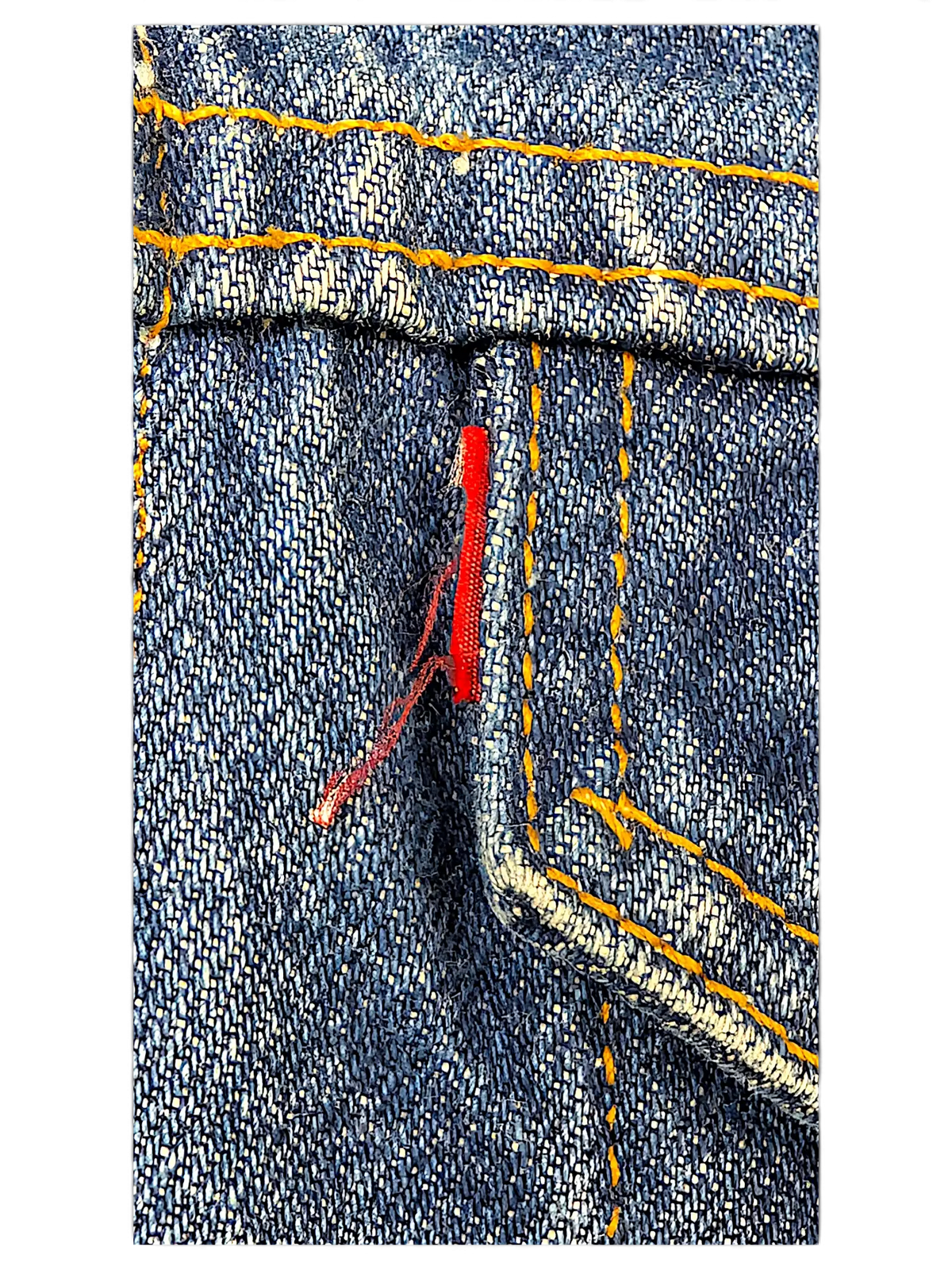 Close-up of a JAKE & IPI Levi's denim jacket showing blue fabric, orange contrast stitching, and a red tab detail.