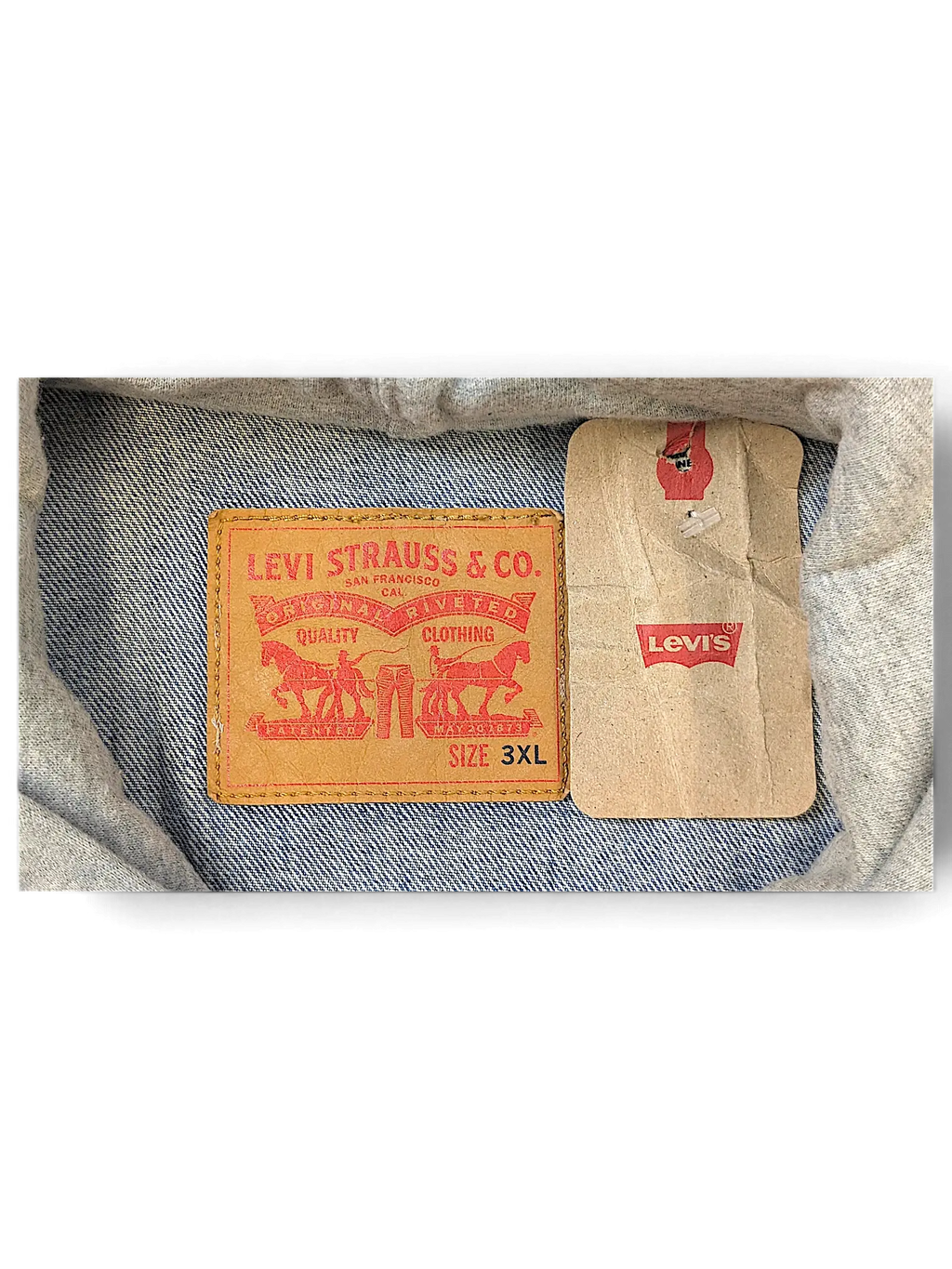 JAKE & IPI Levi's denim jacket interior label showing size 3XL and brand logo with attached paper tag