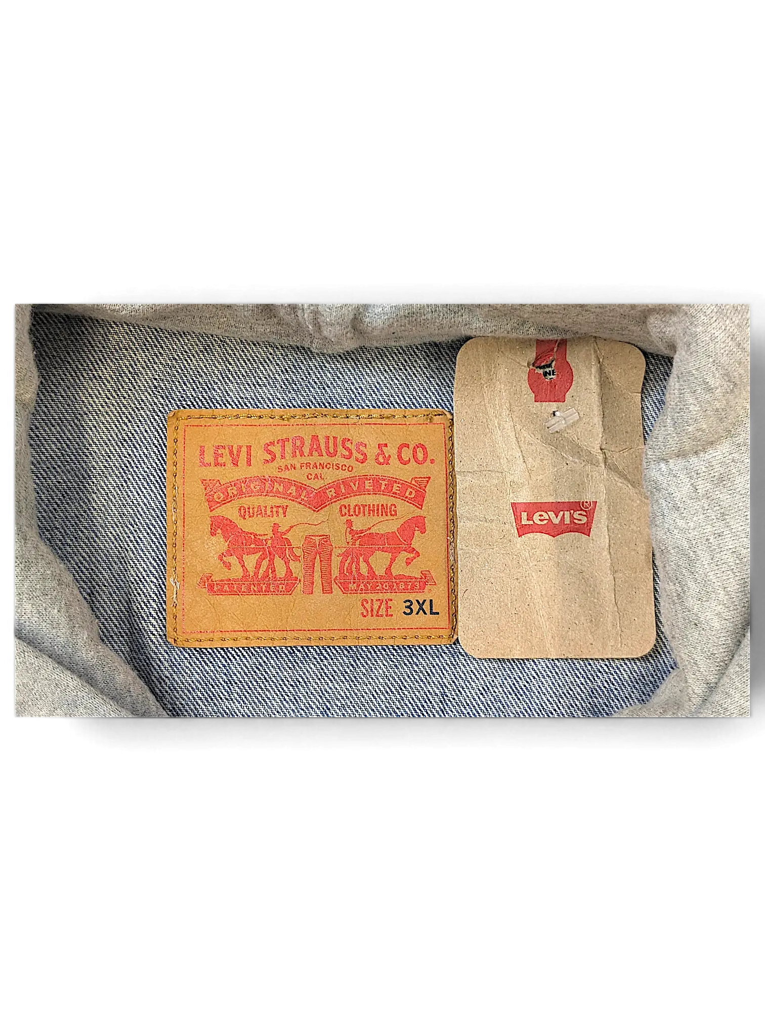 JAKE & IPI Levi's denim jacket interior label showing size 3XL and brand logo with attached paper tag