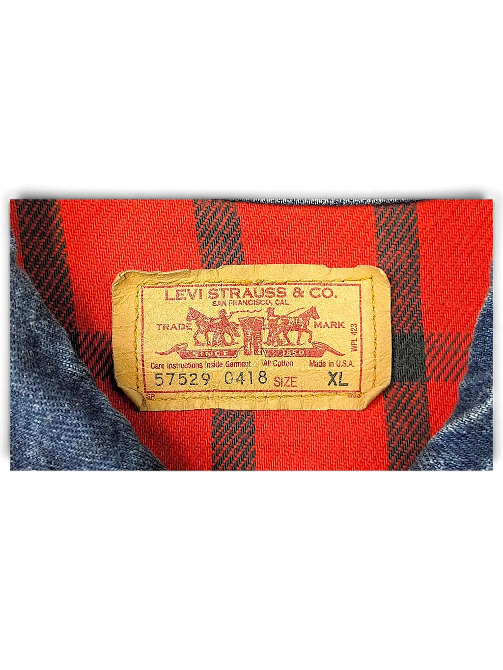 JAKE & IPI Levi's denim jacket interior label with red and black plaid quilted lining and size XL tag