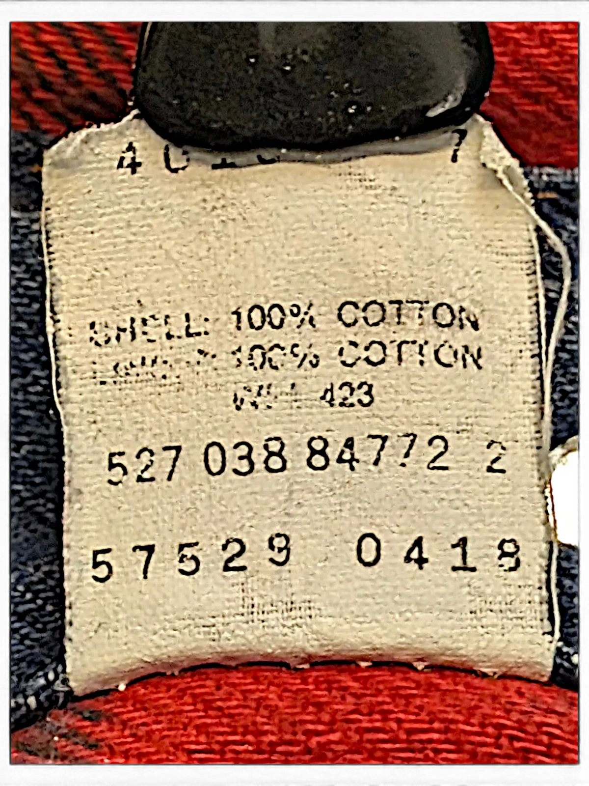 JAKE & IPI Levi's denim jacket interior label showing 100% cotton material and red plaid quilted lining