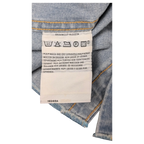 JAKE & IPI Levi's denim shirt care label with washing instructions in multiple languages on light blue denim fabric