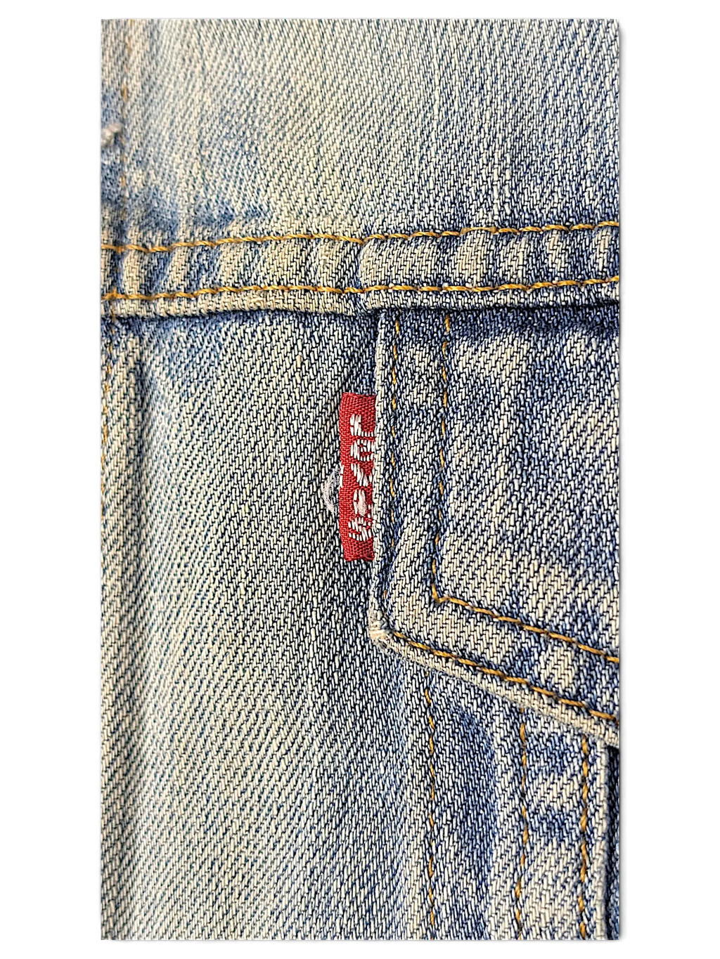 Close-up of a JAKE & IPI Levi's distressed washed blue denim jacket featuring a red brand tab on the chest pocket.