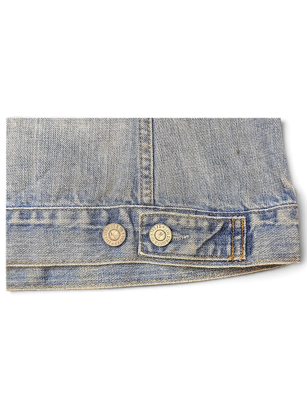 Close-up of JAKE & IPI Levi's distressed light wash denim jacket hem with branded metal buttons