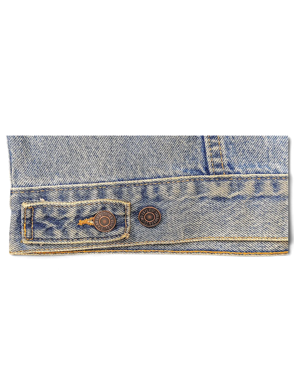 Close-up of a JAKE & IPI Levi's Strauss distressed light blue denim jacket hem with branded metal buttons.
