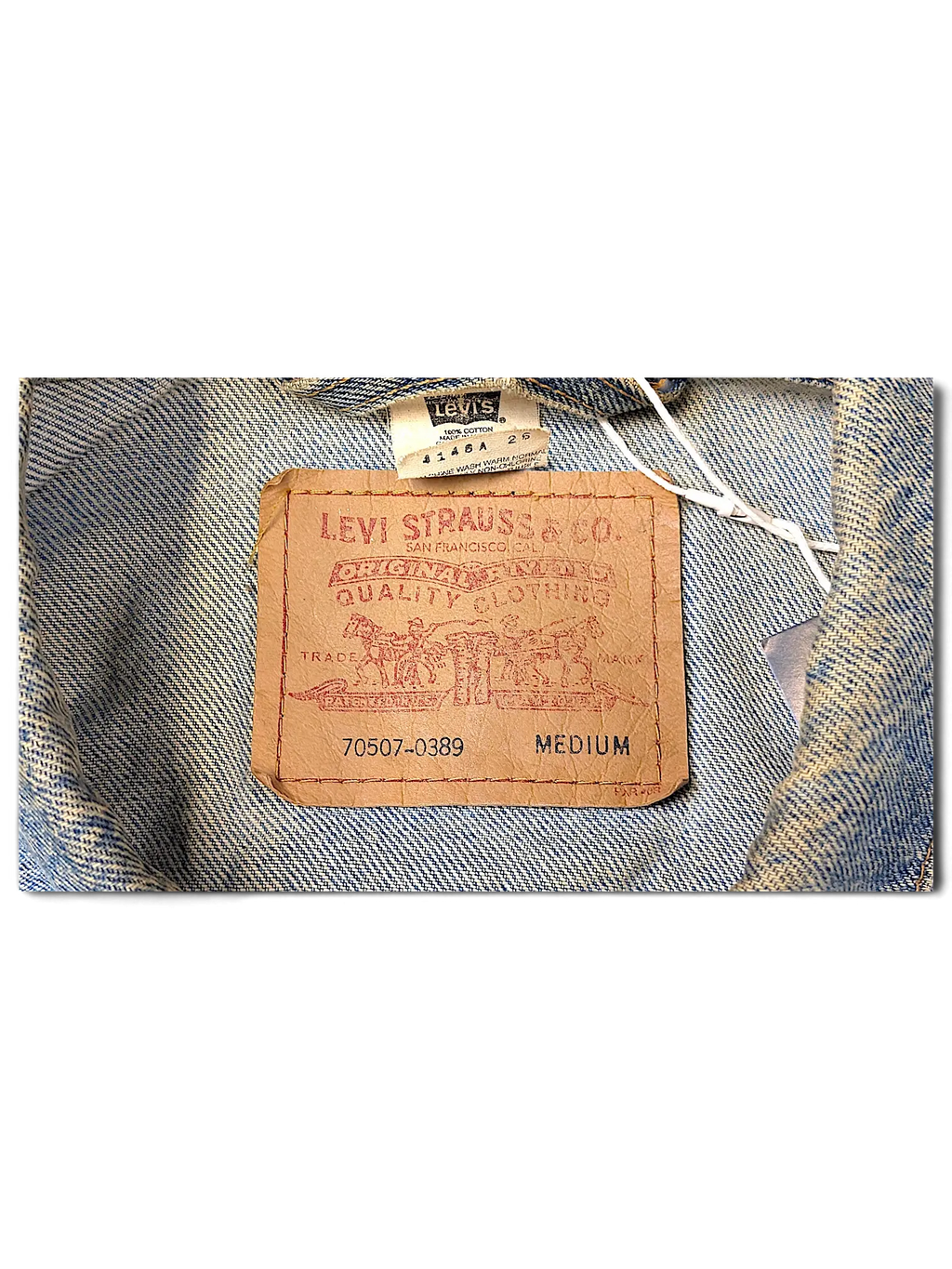 JAKE & IPI Levi's Strauss distressed denim jacket featuring a classic brown leather brand patch and size medium label.