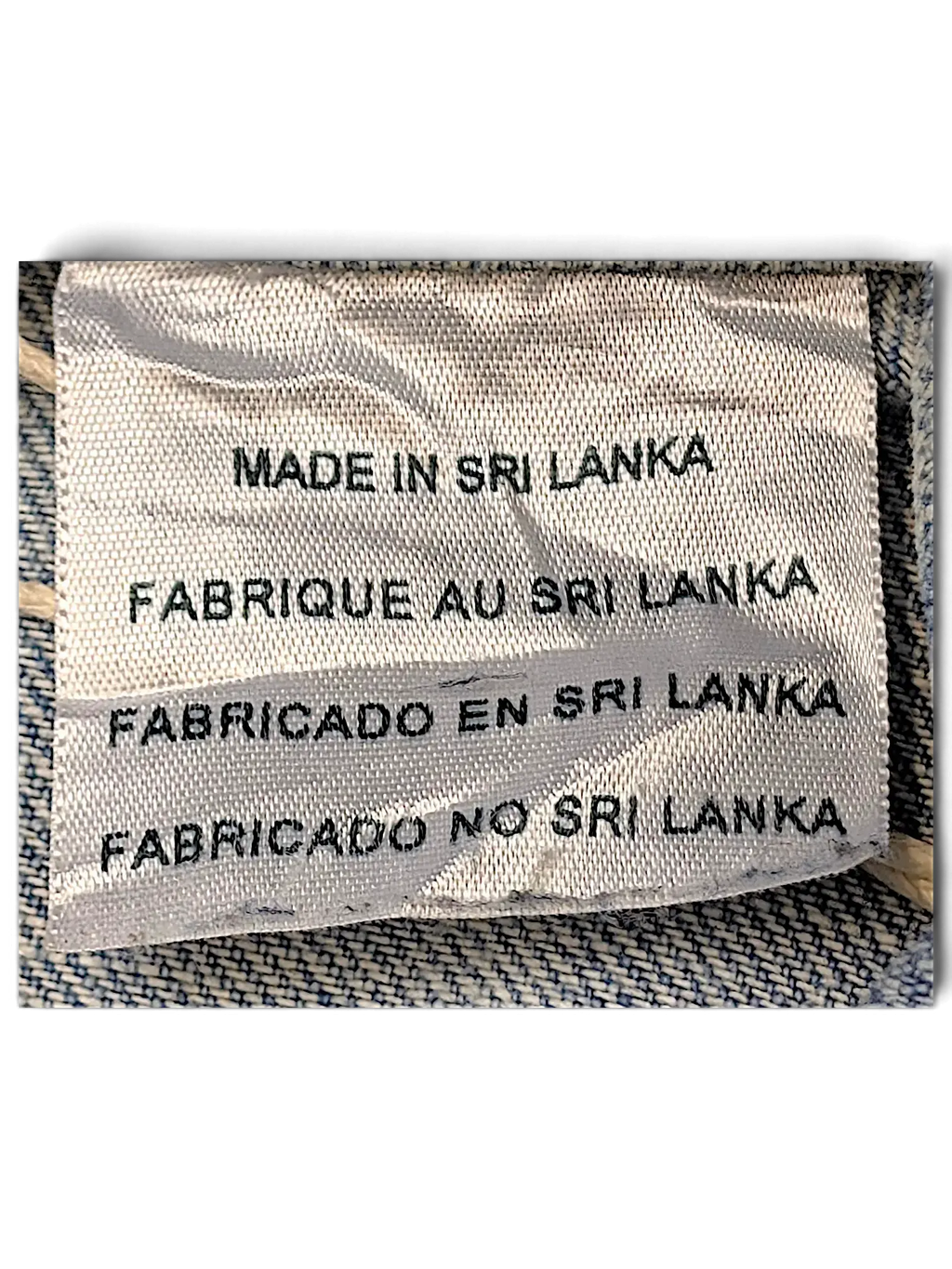 JAKE & IPI Levi's Strauss girls jacket fabric care label showing Made in Sri Lanka text on light blue denim