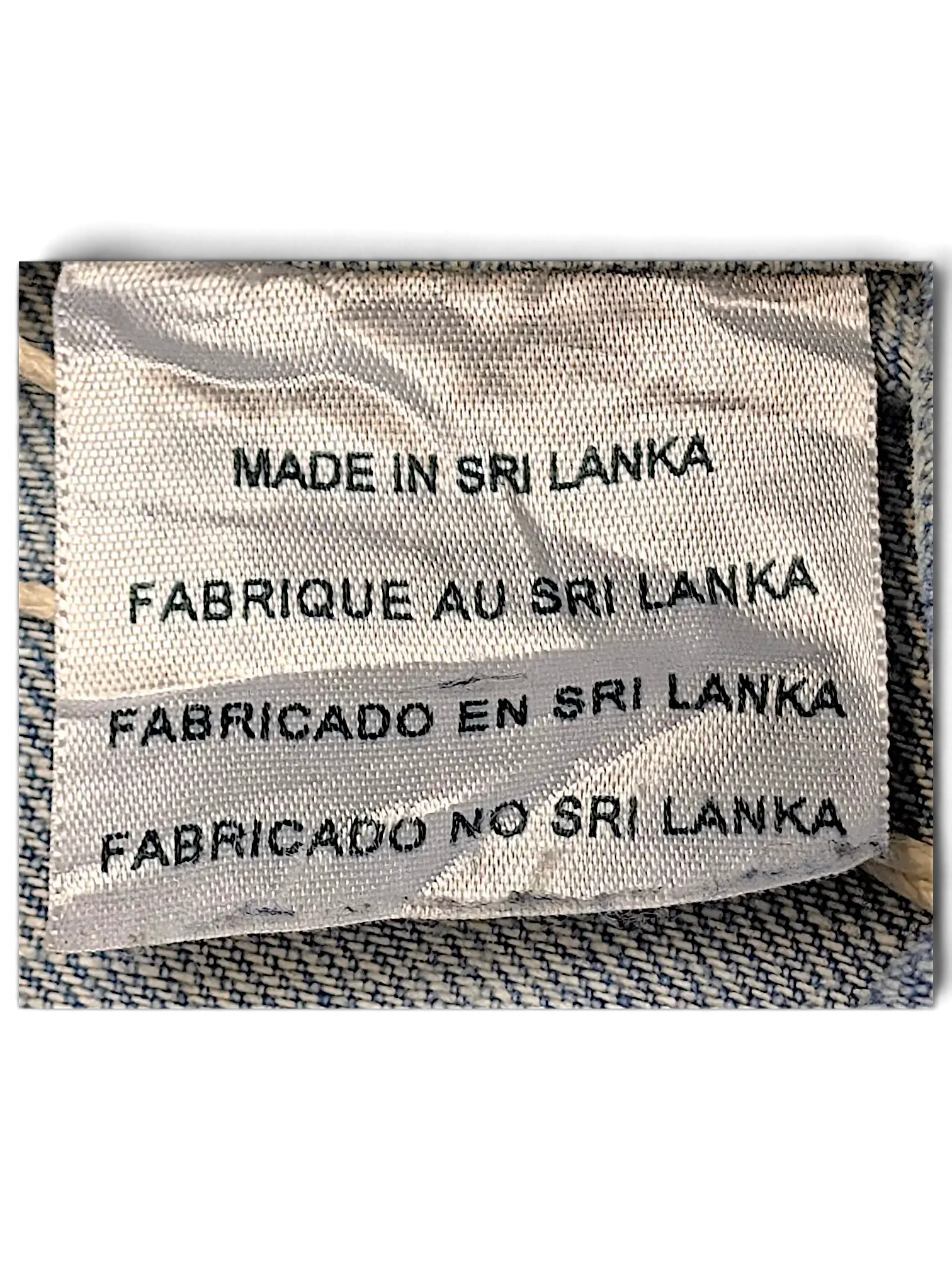 JAKE & IPI Levi's Strauss girls jacket fabric care label showing Made in Sri Lanka text on light blue denim