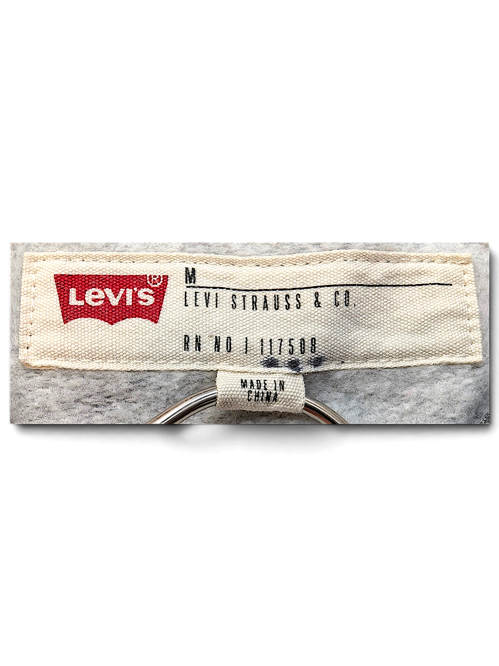 JAKE & IPI Levi's hoodie interior neck label in size medium with grey heathered fleece fabric background