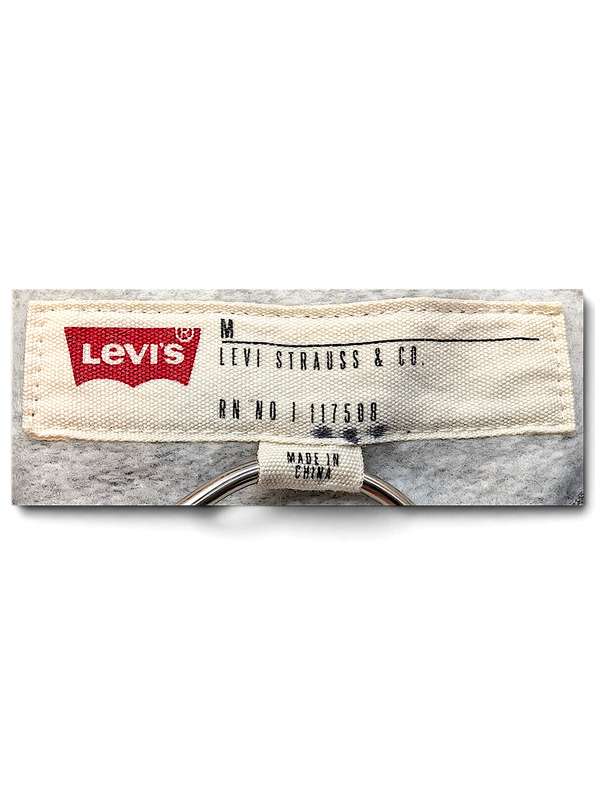 JAKE & IPI Levi's hoodie interior neck label in size medium with grey heathered fleece fabric background