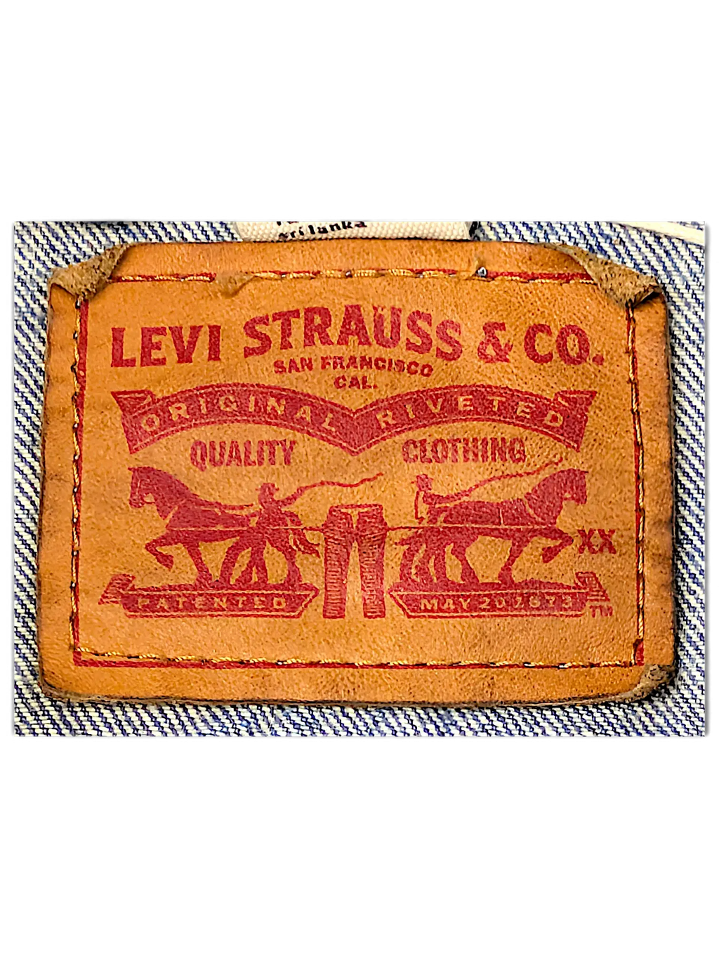 JAKE & IPI Levi Strauss and Co brown leather brand patch on a light blue denim jacket