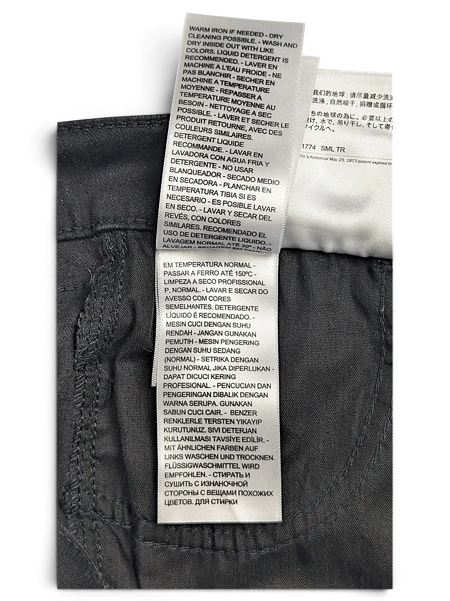 JAKE & IPI Levi's 710 Super Skinny jeans care label with multi-language washing instructions on dark grey fabric