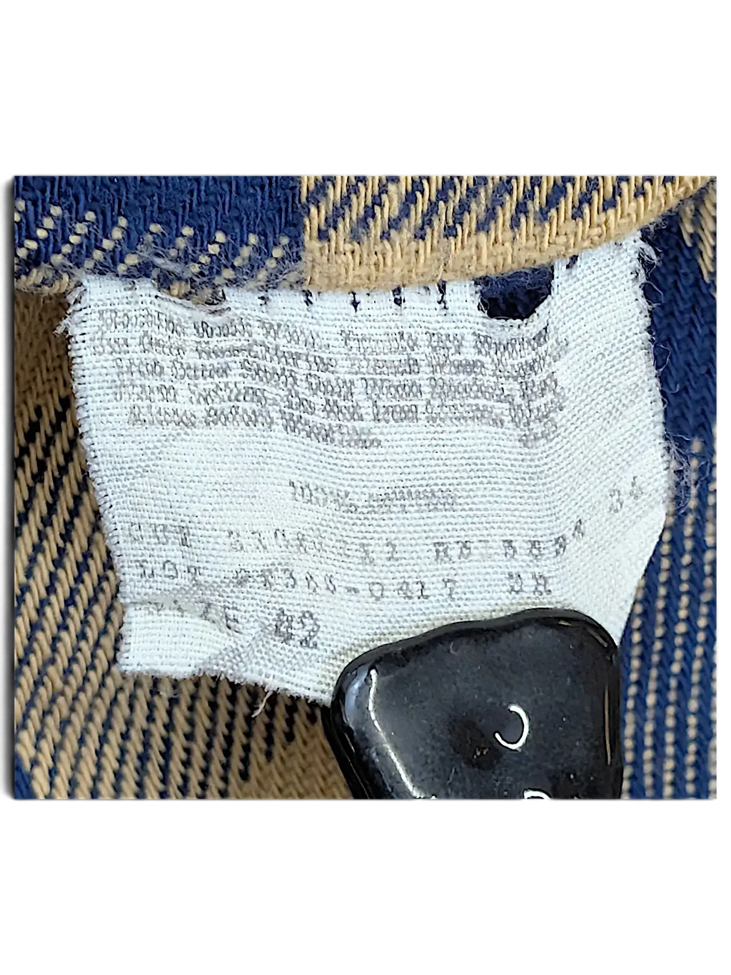 Vintage Levi's denim jacket care label from JAKE & IPI showing 100% cotton composition and size 42
