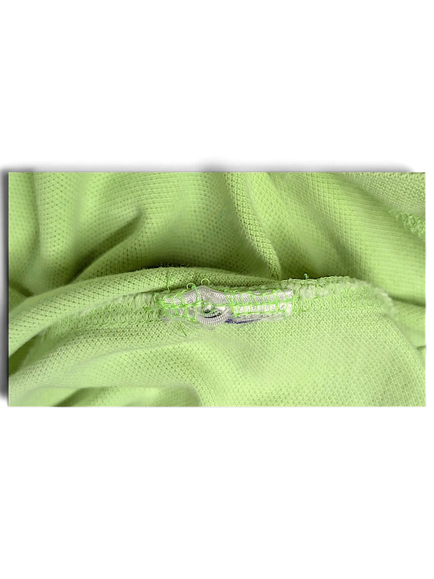 Close-up of JAKE & IPI lime green classic fit polo shirt fabric texture and interior seam detail
