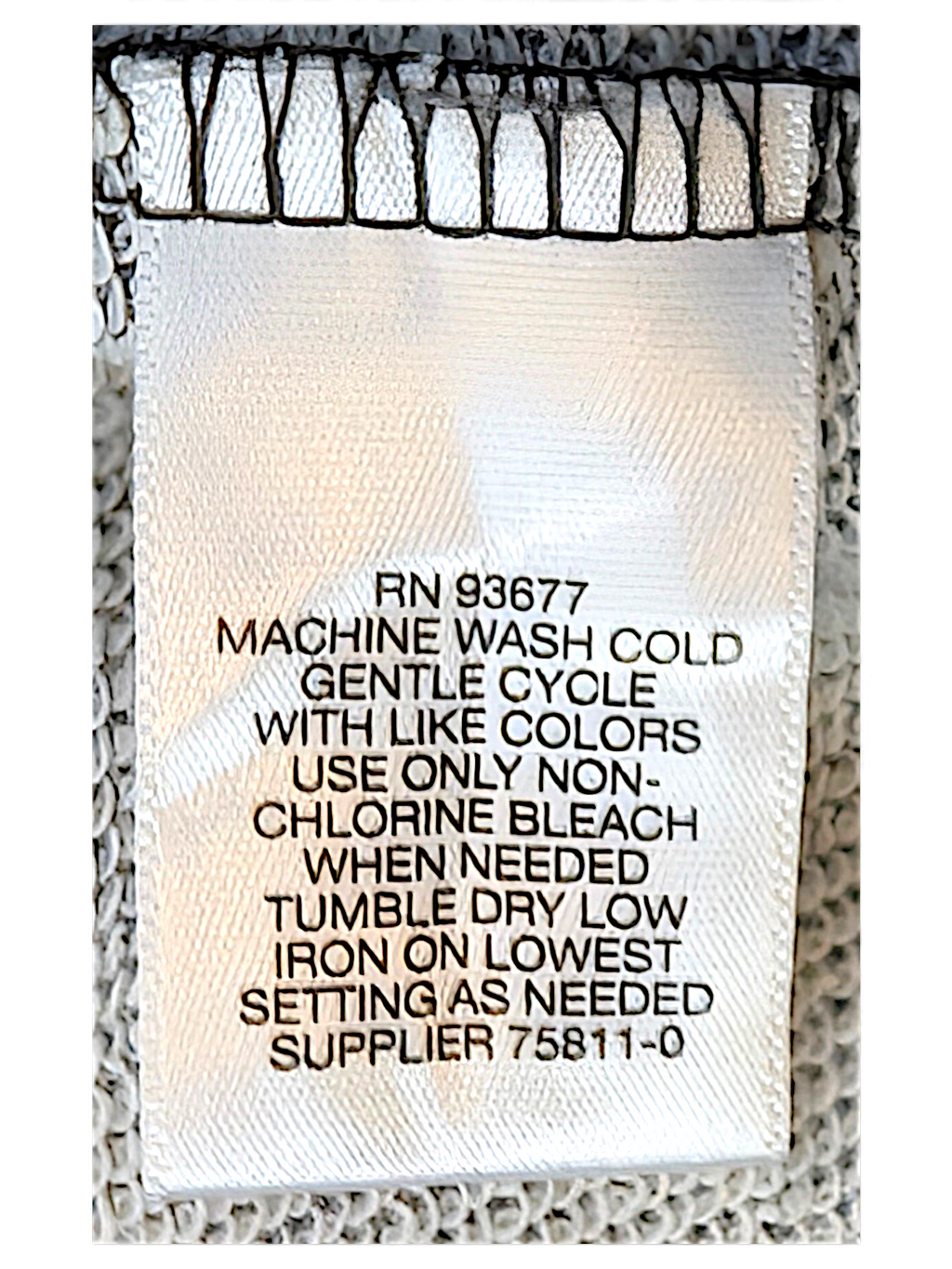 JAKE & IPI LizClaiborne College garment care label with washing instructions on grey marl fabric