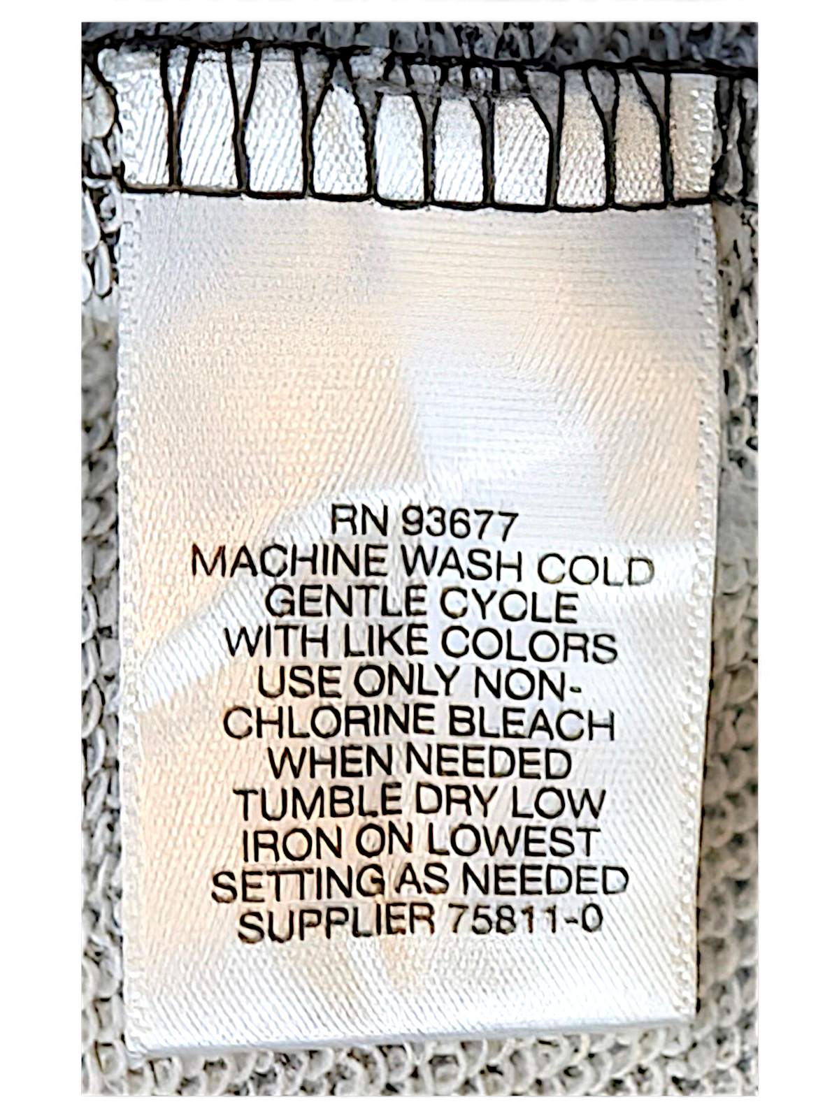 JAKE & IPI LizClaiborne College garment care label with washing instructions on grey marl fabric