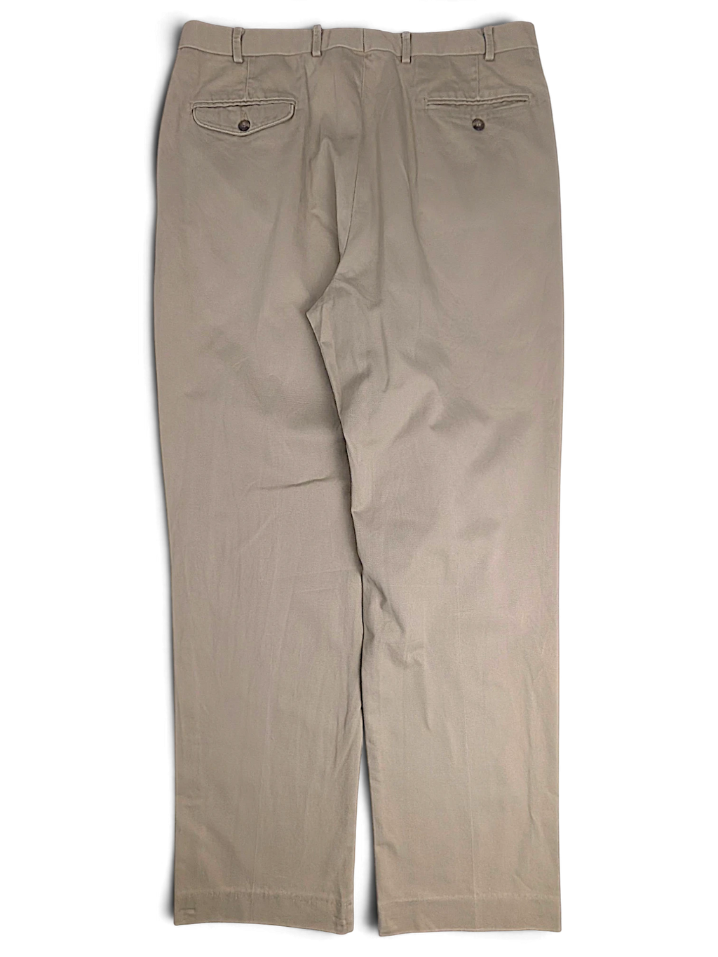 Back view of JAKE & IPI L.L.Bean beige pleated chinos featuring two buttoned back pockets on a plain background.