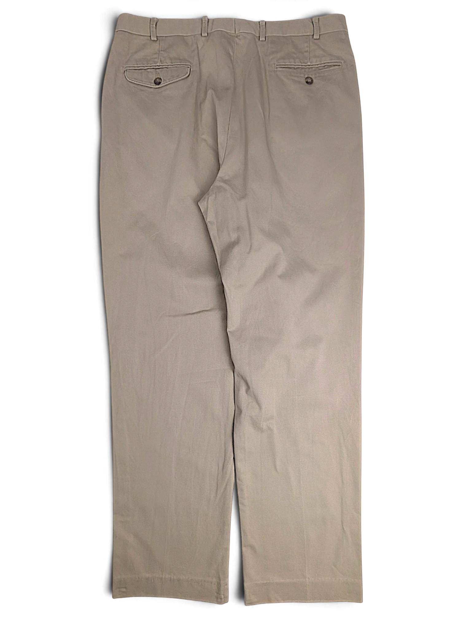 Back view of JAKE & IPI L.L.Bean beige pleated chinos featuring two buttoned back pockets on a plain background.