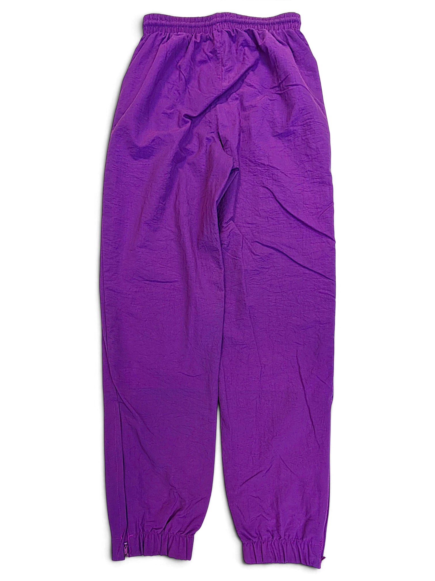 JAKE & IPI pre-owned Lotto purple track pants with an elasticated waistband and cuffed ankles.