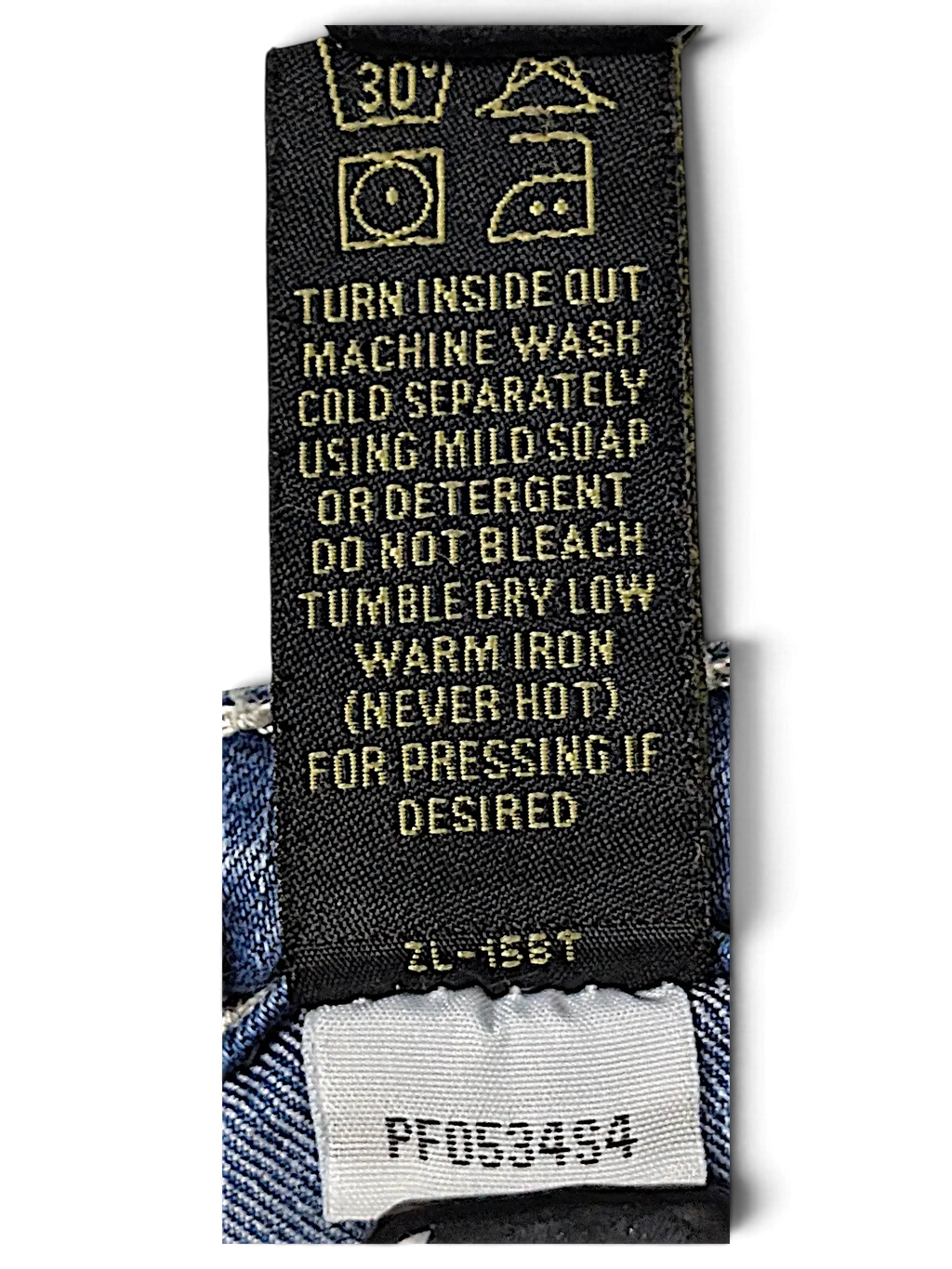 JAKE & IPI Love X Indigo Y2K jeans care label with washing instructions and product code on blue denim fabric