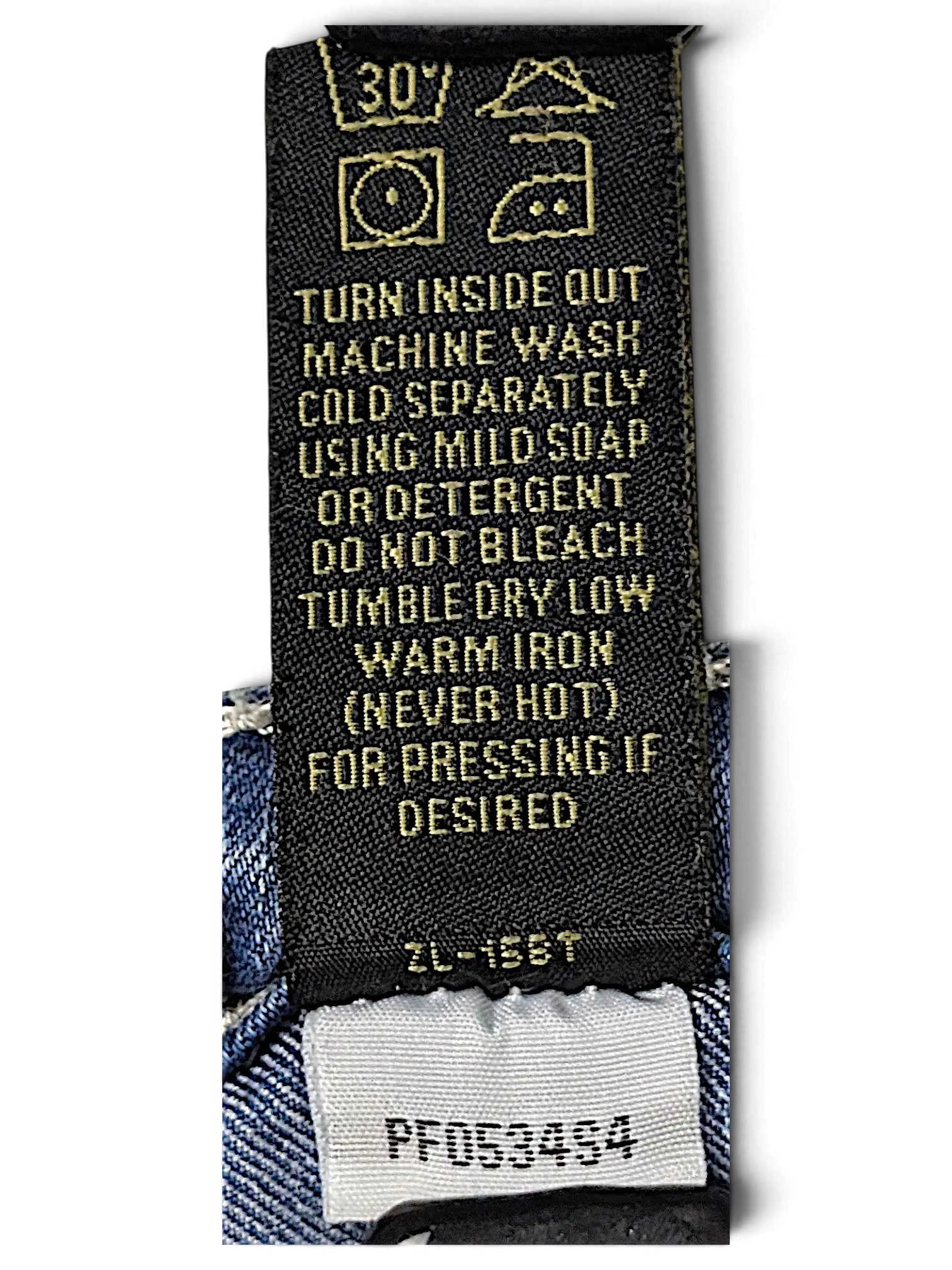 JAKE & IPI Love X Indigo Y2K jeans care label with washing instructions and product code on blue denim fabric
