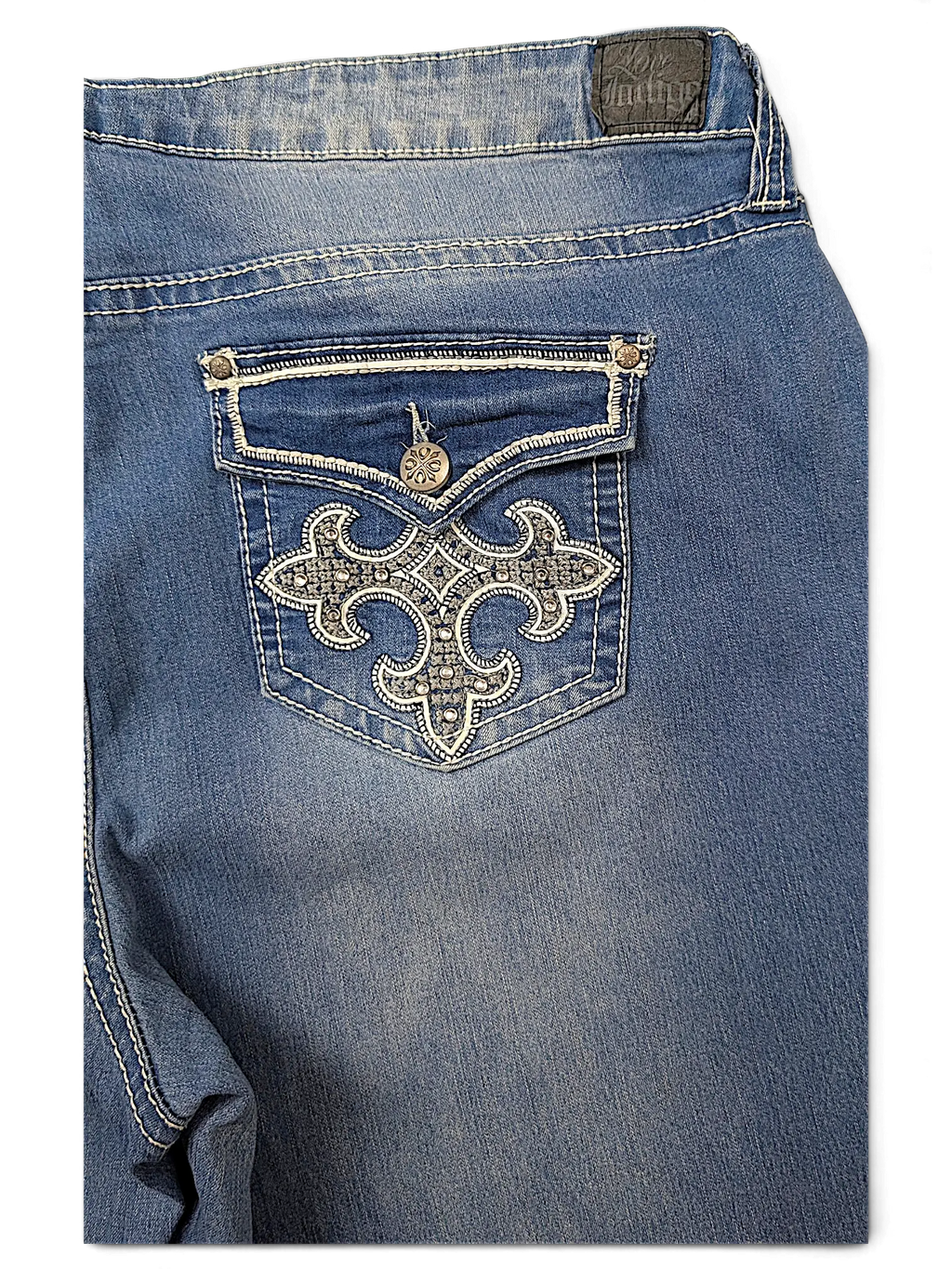 JAKE & IPI Love X Indigo Y2K jeans featuring a back pocket with intricate silver embroidery and stud detailing.