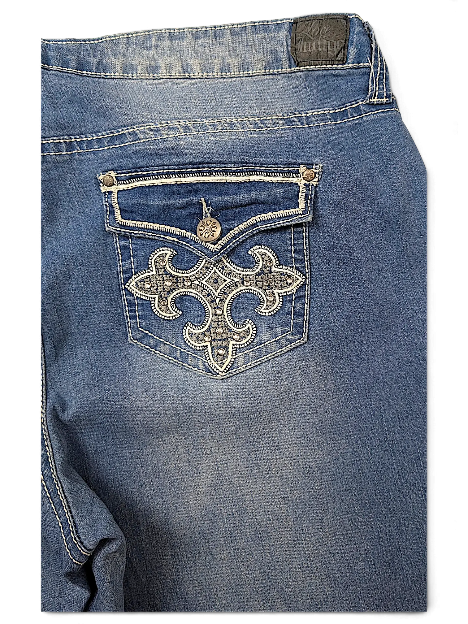 JAKE & IPI Love X Indigo Y2K jeans featuring a back pocket with intricate silver embroidery and stud detailing.