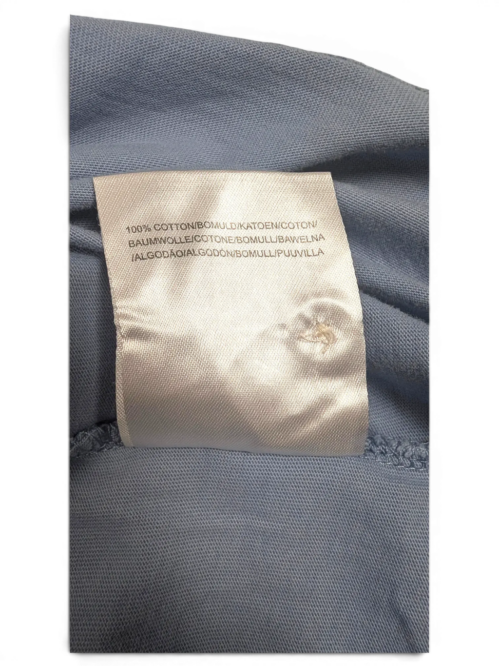 JAKE & IPI Lyle & Scott polo shirt interior label showing 100 percent cotton material composition