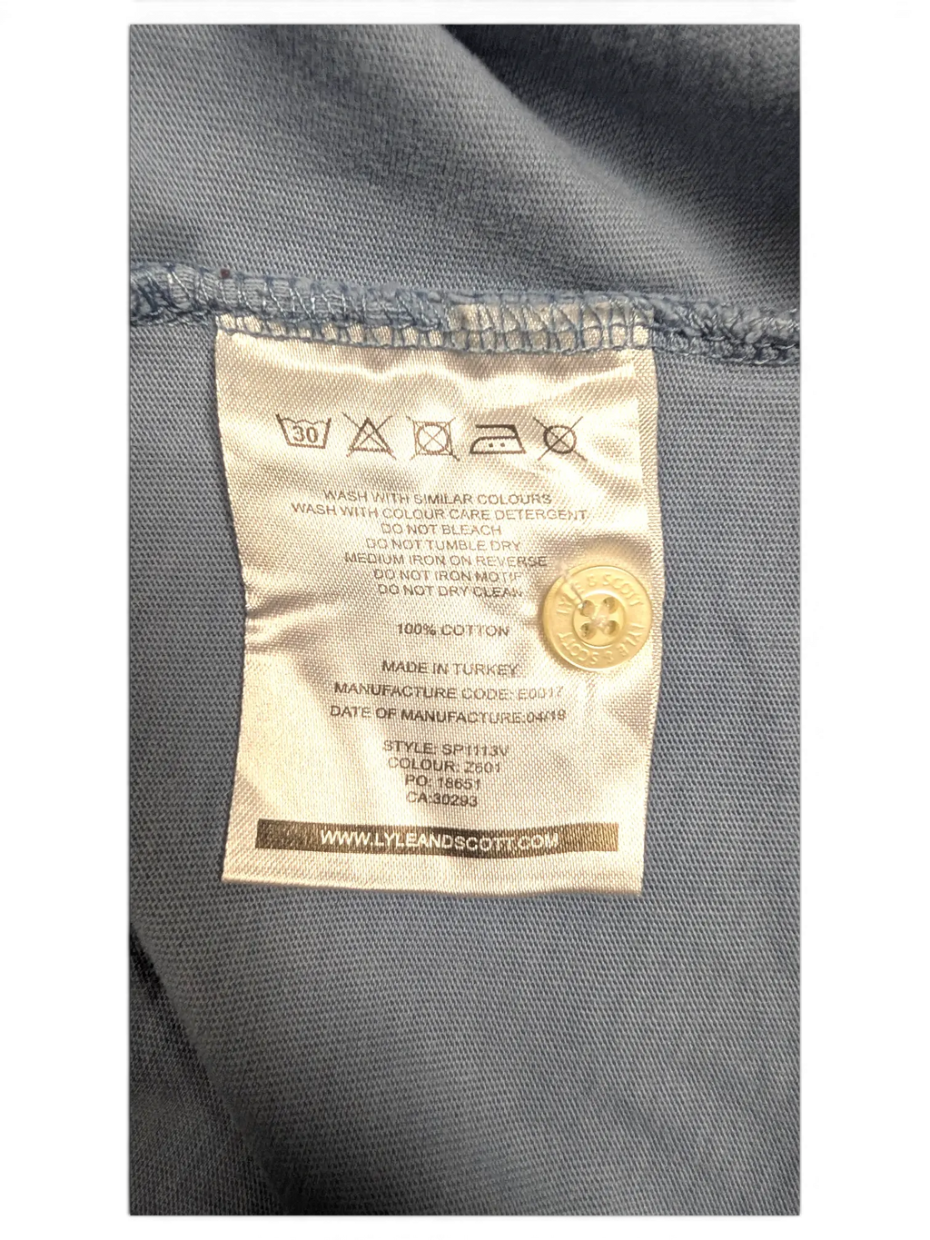 JAKE & IPI Lyle & Scott polo shirt care label showing 100 percent cotton material and washing instructions