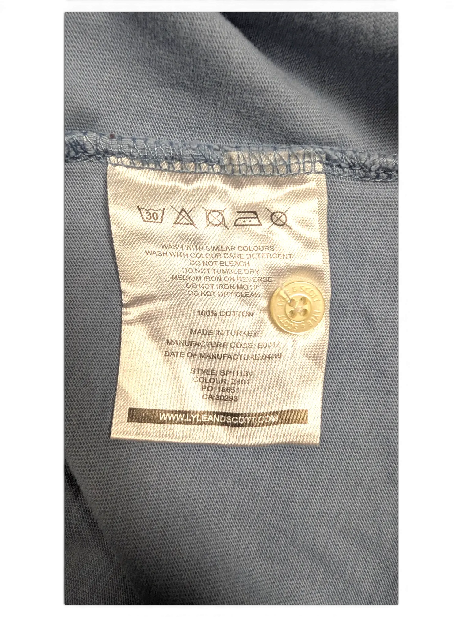 JAKE & IPI Lyle & Scott polo shirt care label showing 100 percent cotton material and washing instructions