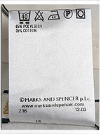 JAKE & IPI Marks & Spencer clothing care label showing 65 percent polyester and 35 percent cotton fabric composition
