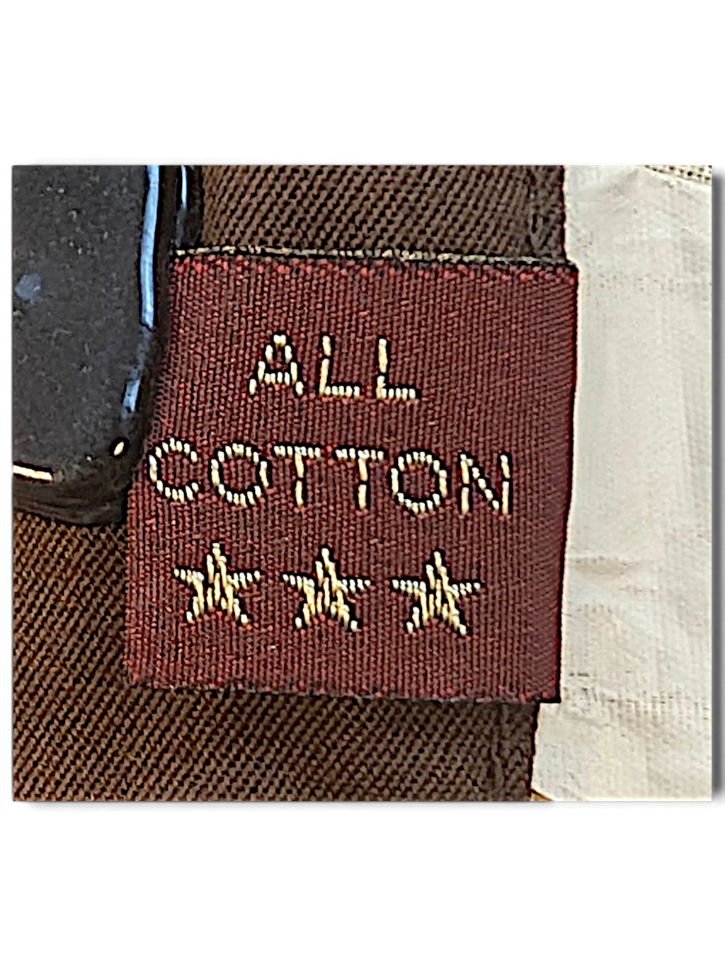 JAKE & IPI Marlboro Classics brown cotton chino label detail showing All Cotton text and three embroidered stars