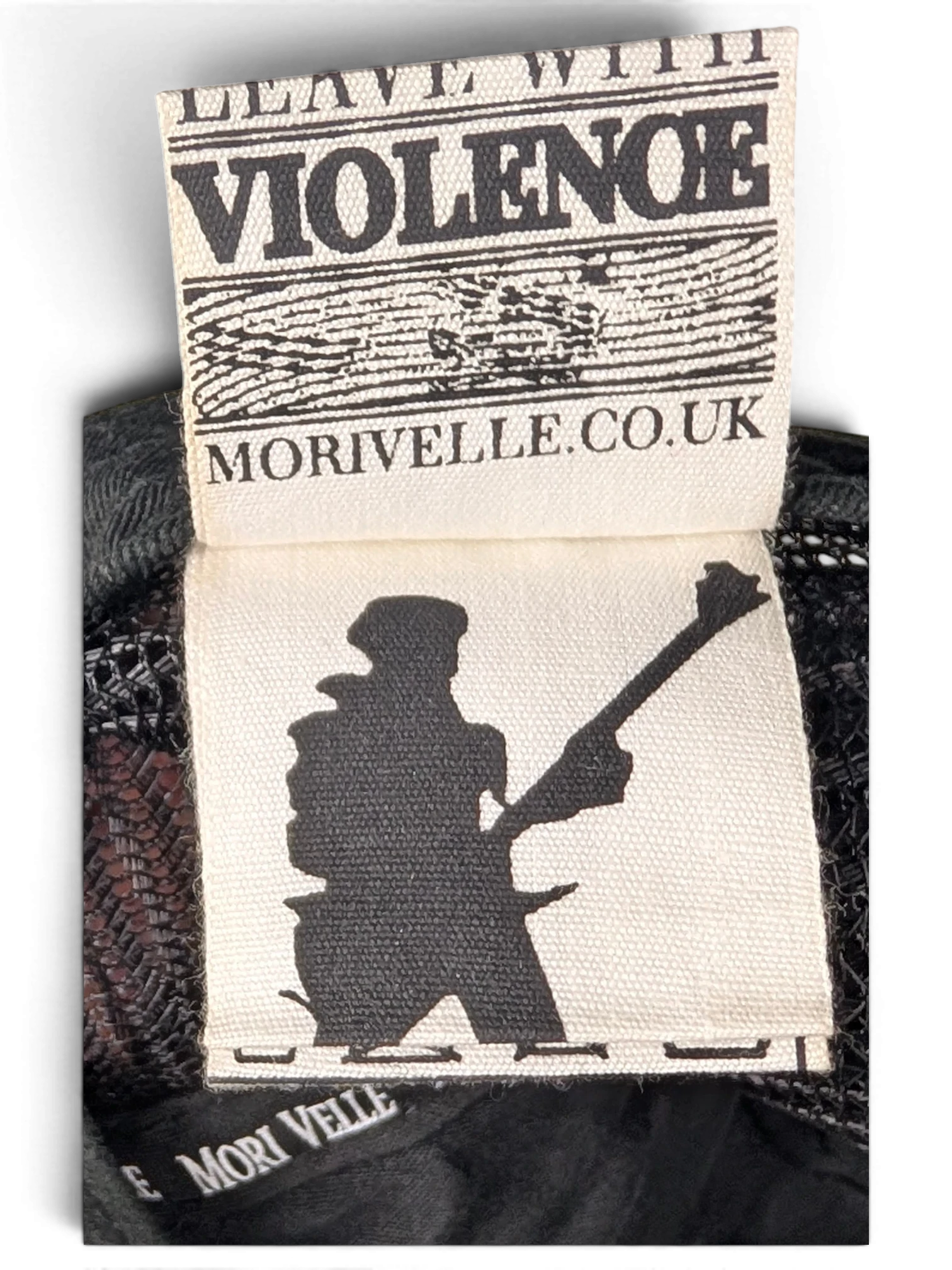 JAKE & IPI IBE Morivelle cap interior fabric label with Leave With Violence branding and musician silhouette graphic